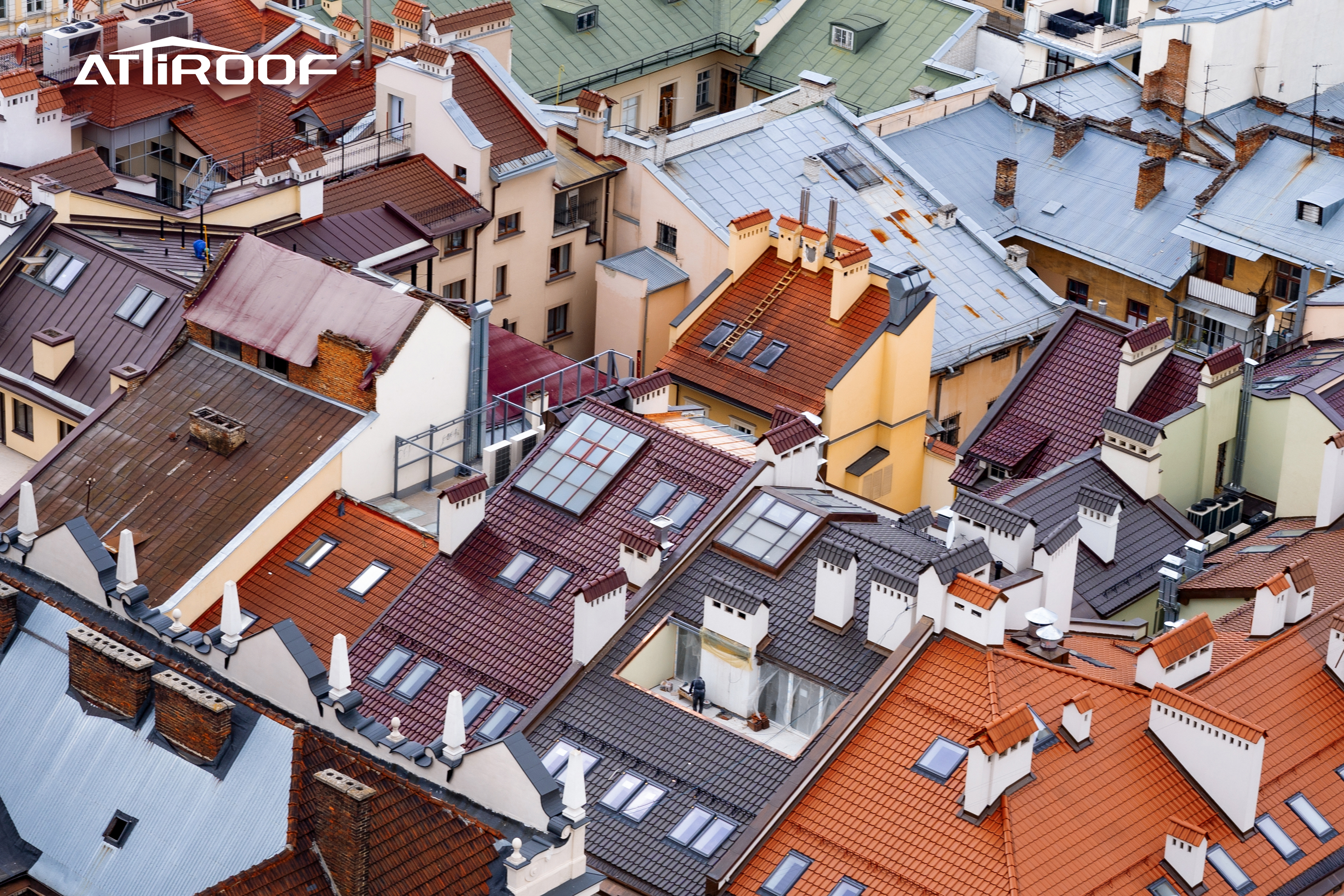 Aerial view of a dense neighborhood with a variety of textured synthetic resin roof tiles in multiple colors.